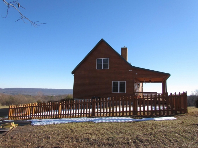 Cedar Siding Custom Home side view with fence