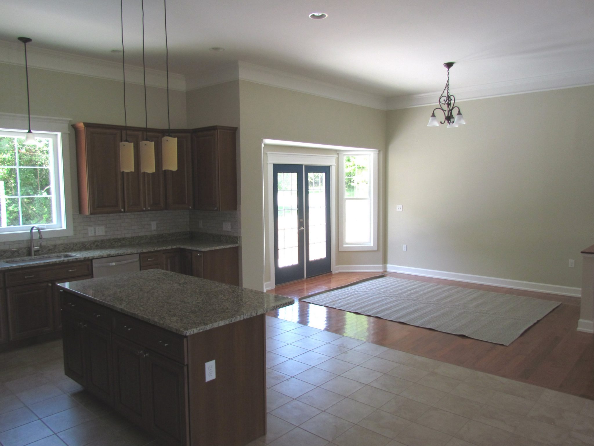 Custom Home With In-Ground Pool kitchen island and back door
