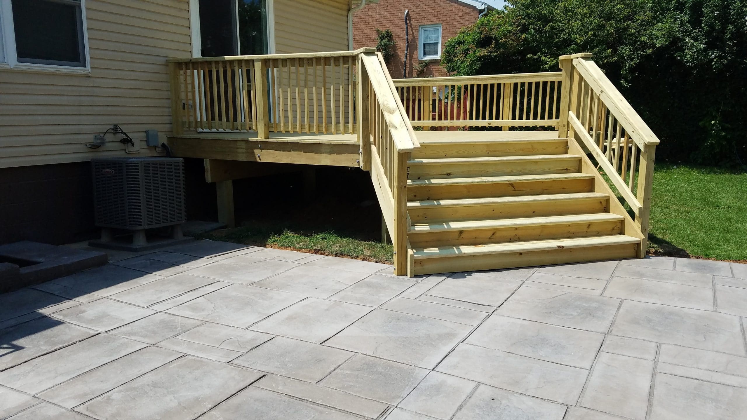 pressure treated deck and stamped concrete patio