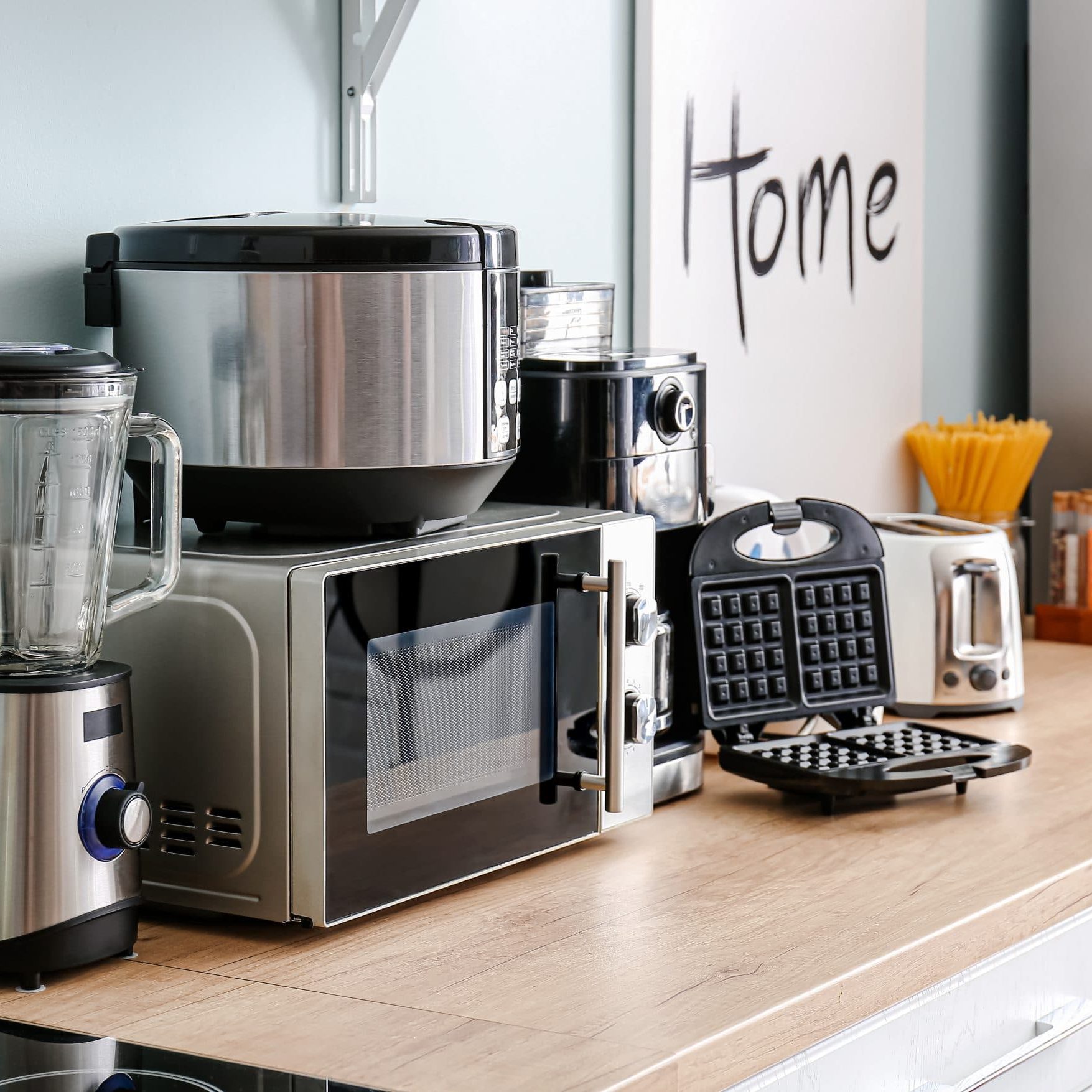 Different household appliances on table in kitchen