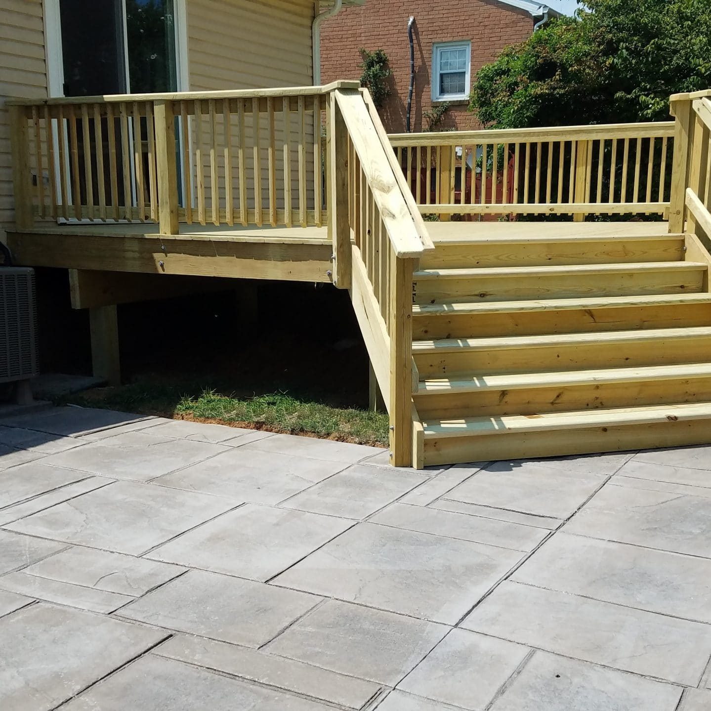 pressure treated deck and stamped concrete patio
